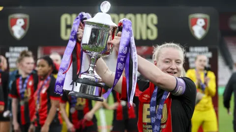 Bournemouth captain Abby Jones lifts the trophy