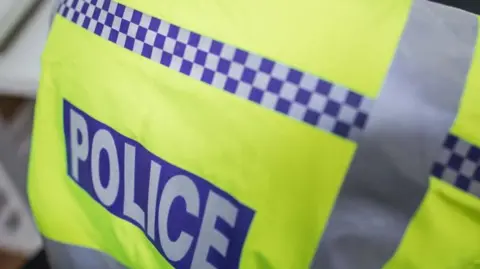 Getty Images A hi-vis yellow and blue police jacket.