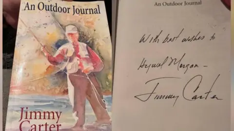 A copy of Jimmy Carter's autobiography with a hand written dedication to Hywel Morgan