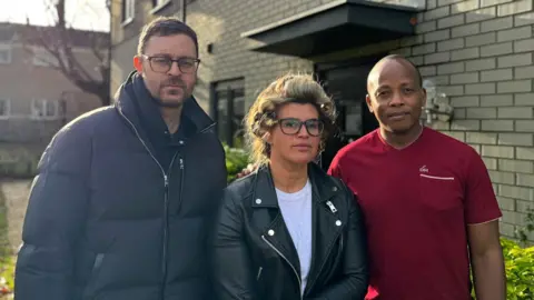 Robert Altman, Georgina Bright and Themba  standing in front of their Bellway homes in Brentwood