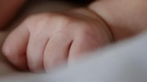 The hand of a newborn baby.