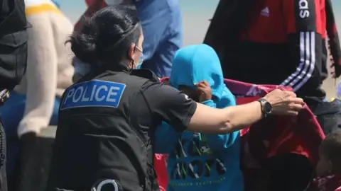 Susan Pilcher A police woman is helping some young asylum seekers, who are wearing hoodies