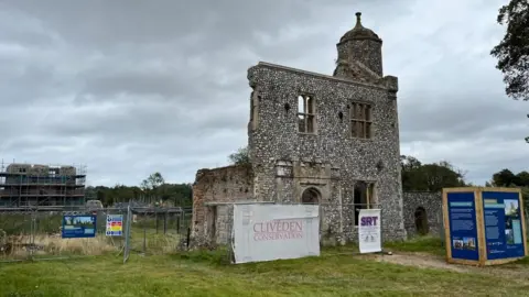 Andrew Turner/BBC Outer gatehouse of Baconsthorpe Castle, with the castle and inner gatehouse in the distance