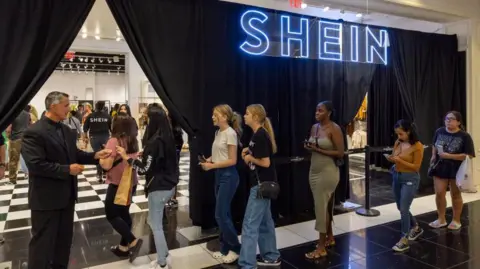 Getty Images People enetring a Shein pop-up shop