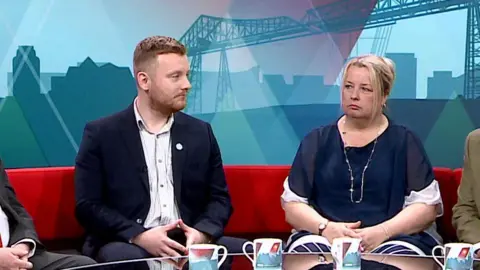 Eynon and Hopgood stare at each other which sat on the BBC Politics North sofa.