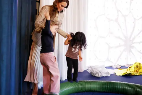 PA Media The Princess of Wales plays with children in a early years centre in Italy.