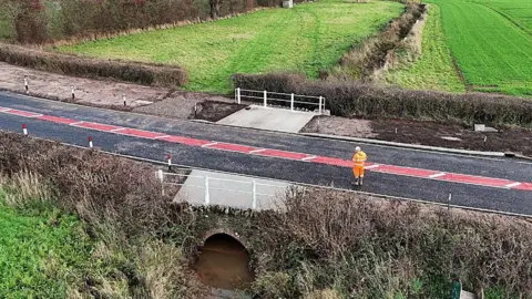 Herefordshire Council An aerial shot of a road in Herefordshire with a brook running underneath it