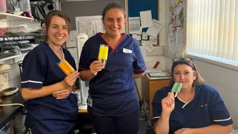 University Hospital Southampton Three nurses hold ice lollies in a hospital office