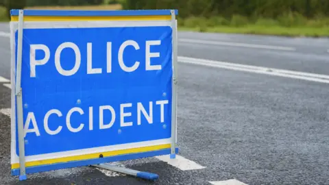 Police accident sign beside an empty road