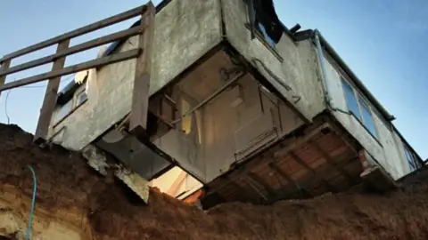 Martin Barber/BBC Bunglow hanging over cliff