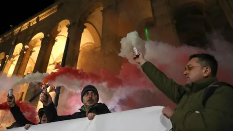 Reuters Protesters hold a fire in the Georgian capital Tbilisi