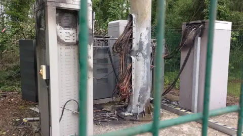 A view of the set alight 5g mast