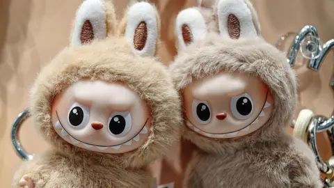 A pair of mini-versions of the popular toy Labubu in an outlet of Pop Mart in China