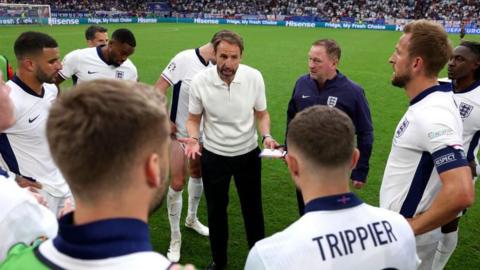 England manager Gareth Southgate talks to his players during extra time of their Euro 2024 last-16 tie with Slovakia