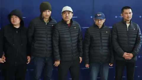 Reuters Released Thai hostages, who were kidnapped during the deadly October 7, 2023 attack by Hamas and held in Gaza, stand together as they arrive in Thailand after being released