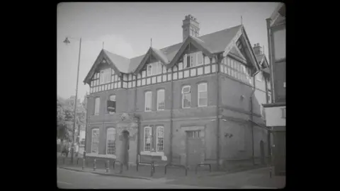 Historic England A black and white photo of the exterior of a pub