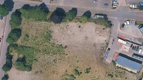 HIGHLAND COUNCIL Ariel shot of land where Inverness College used to be. A large patch of grassy land next to the roadside.