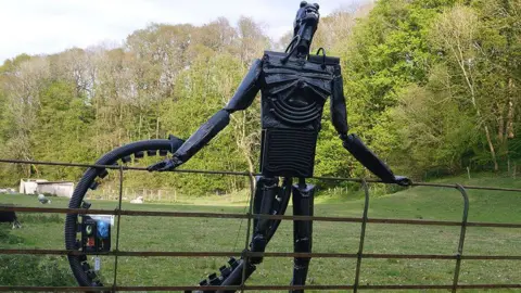 PA Media Black alien scarecrow