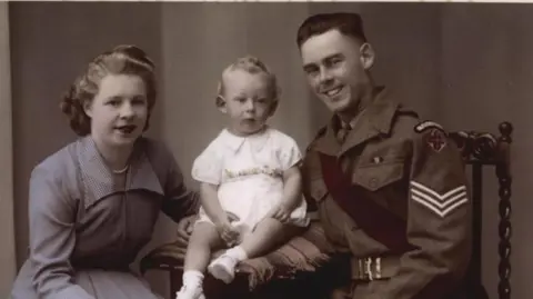 Michael Northey Michael with his father Donald when he was a baby, wearing a military uniform, before he went off to fight