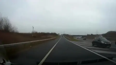 Car on a slip road going the wrong way onto a dual carriageway