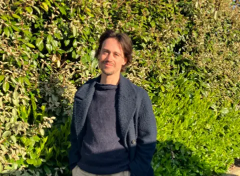 Swede Caroline Man stood near bushes