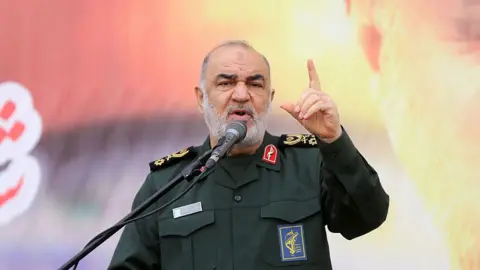 Commander-in-chief of the Islamic Revolutionary Guard Corps, Hossein Salami, speaks into a microphone