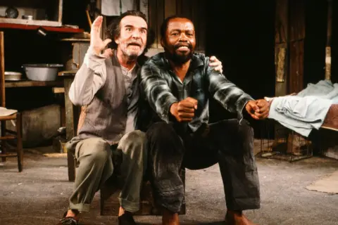 Getty Images Athol Fugard (left) and actor Zakes Mokae in a scene from the play The Blood Knot (by Fugard) at Yale University, New Haven, Connecticut, 1985. The pair starred in the original production in 1961 and again in the Broadway premiere in 1986