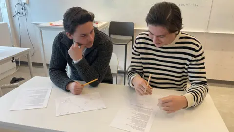 Sixteen-year-old pupils at a high school in Nacka, Sweden, using pencils and paper