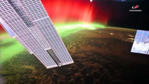 Aurora lights are seen around Earth's surface from the International Space Station.