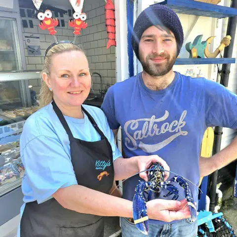 Pete Spencer Polperro fisherman Chris Puckey and fishmonger Jacqueline Spencer with the blue lobster