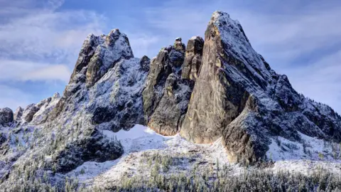 Early Winter Spires, a rocky mountainous area, is shown covered in snow.