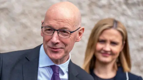 Getty Images John Swinney and Mairi McAllan