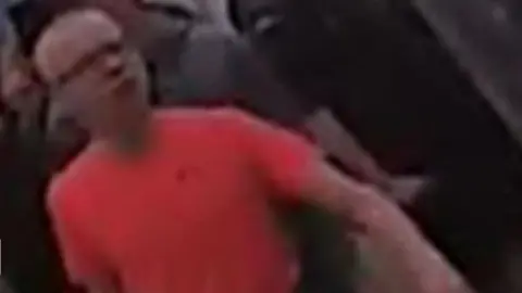 South Yorkshire Police A man with glasses and a red t-shirt