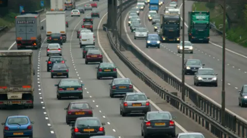 Getty Lots of cars and vans driving on the motorway. Both sides of the motorway are visable. 