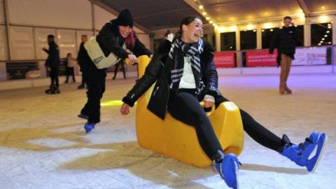 Two skaters enjoying the ice rink