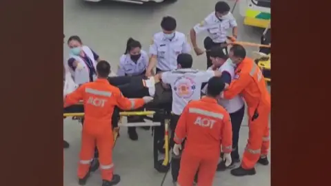 Medics surround a person on a stretcher