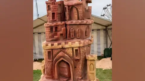 Shane Green A sand sculpture of a detailed sandcastle.