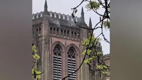 Smoke coming out of tower of cathedral