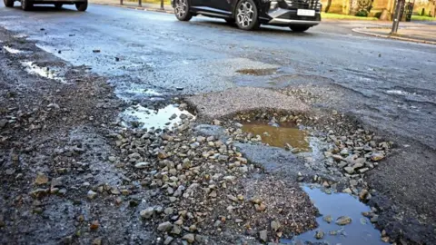 Getty Images Potholes in road