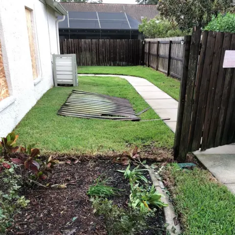 Anne Frost Damaged fences at the Frost family's home in Tampa. 