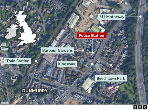 A map of the Dunmurry area taken from overhead, showing the location of the police station and otehr nearby streets.