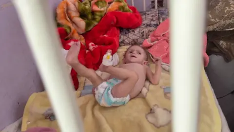 சிவர் ஆஷூரின் படம் அவரது படுக்கையில் உள்ளது