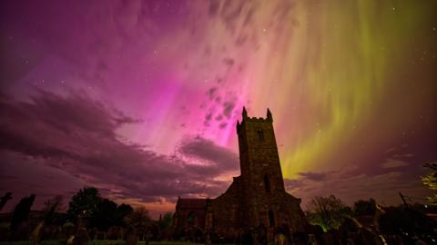 A church with a colourful sky beyond