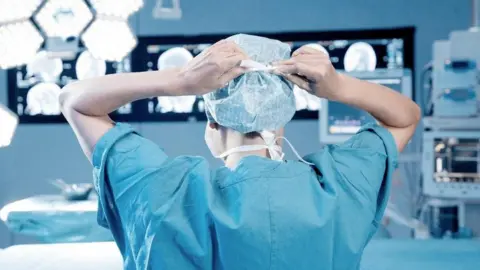 Getty Images A doctor prepares for an operation