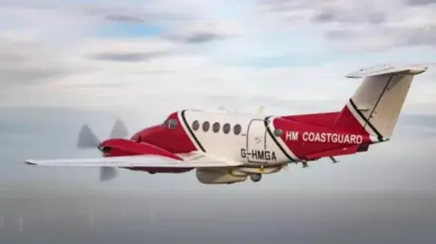 Red and white Maritime & Coastguard Agency (MCA) aeroplane.