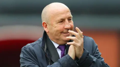 John Coleman applauds during an Accrington game