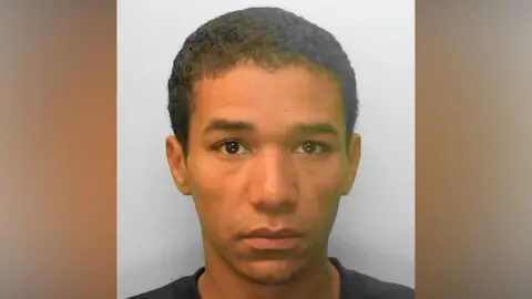 Sussex Police A man in a black top with short black hair.