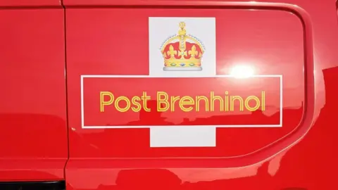 Ian Elcock A close up of the Post Brenhinol logo. It is the same as the Royal Mail one, with a crown above the lettering.