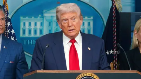 Donald Trump is talking to the press.