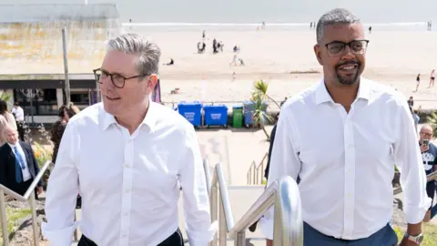 PA Media Sir Keir Starmer and Vaughan Gething walking steps at Barry Island